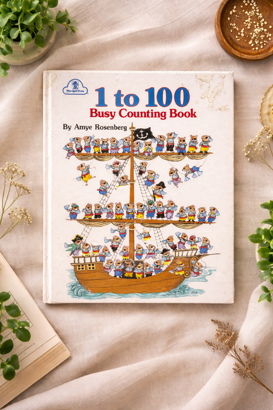 Children's book titled '1 to 100 Busy Counting Book' by Amye Rosenberg on a light background with decorative elements.