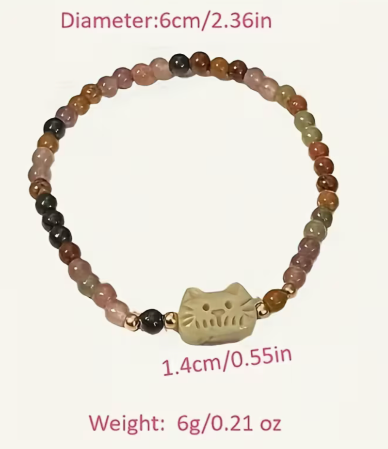 Pastel beaded stretch bracelet with carved cat charm centered, diameter 6 cm.