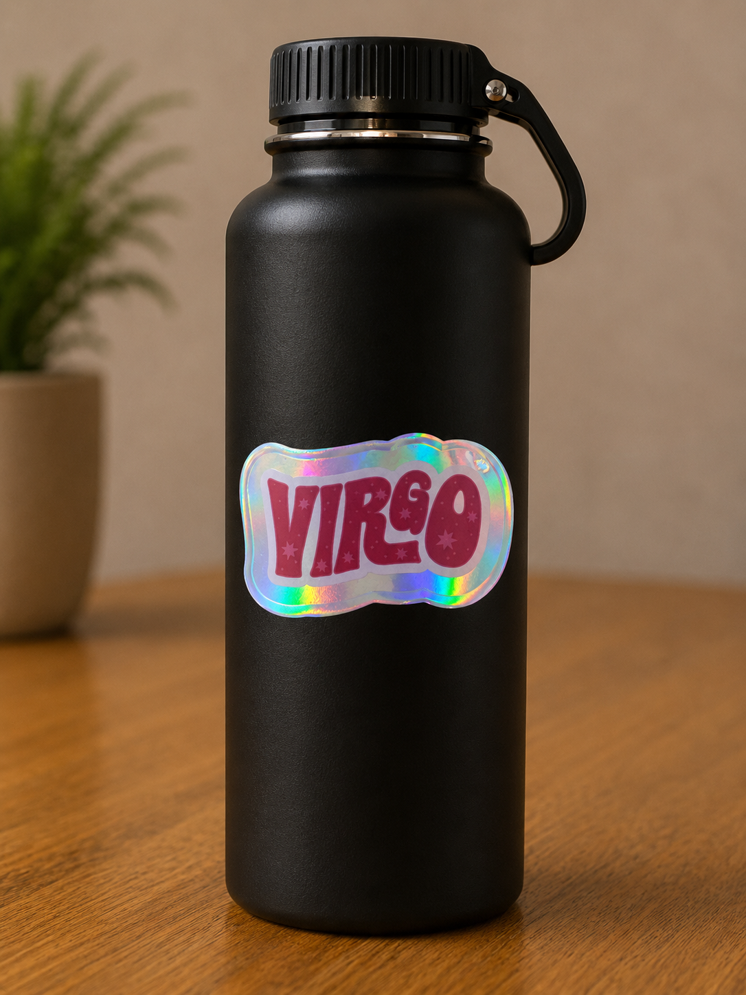 Holographic Virgo zodiac vinyl sticker on a black insulated water bottle featuring retro astrology lettering.