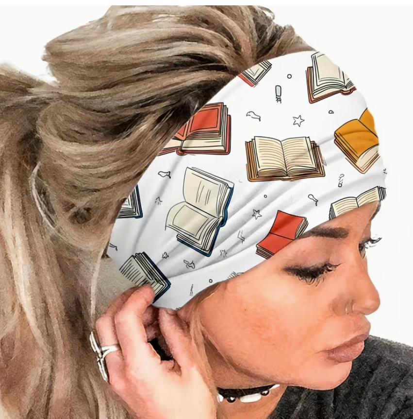 White twist headband featuring colorful scattered books and open book illustrations, soft stretchy fabric for reading, yoga, running, travel, and everyday wear.