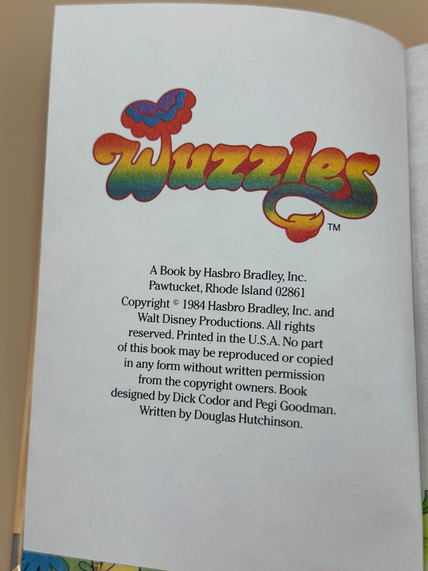 Book page with 'Wuzzles' logo and copyright information