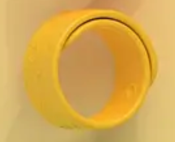 Yellow rubber band on a beige background