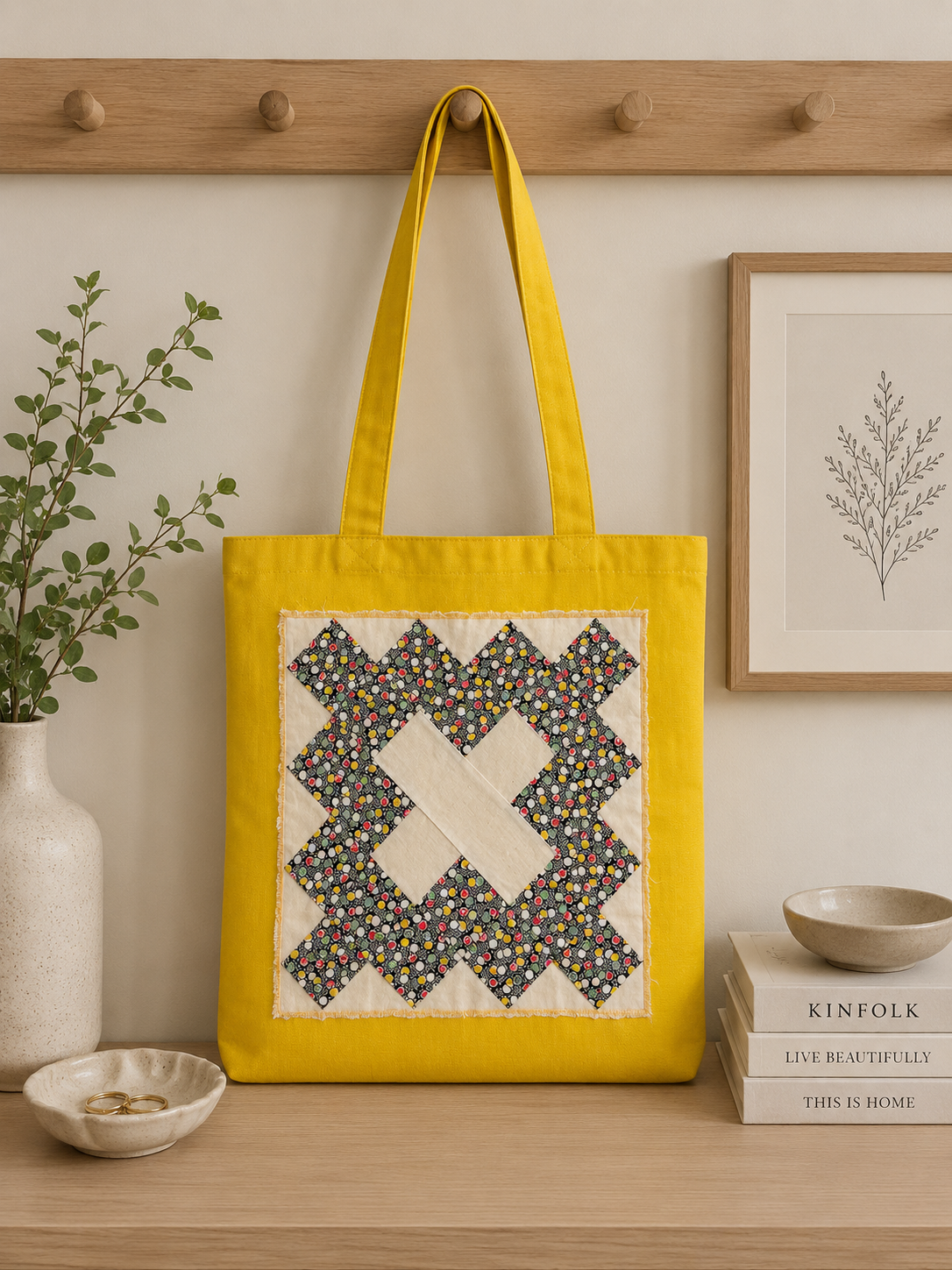 Yellow canvas tote bag featuring colorful floral quilt-inspired patchwork detail