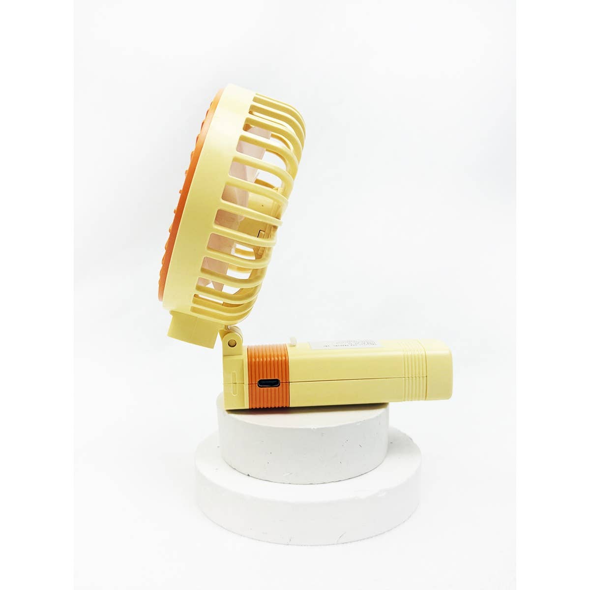 Side profile of yellow adjustable portable handheld fan