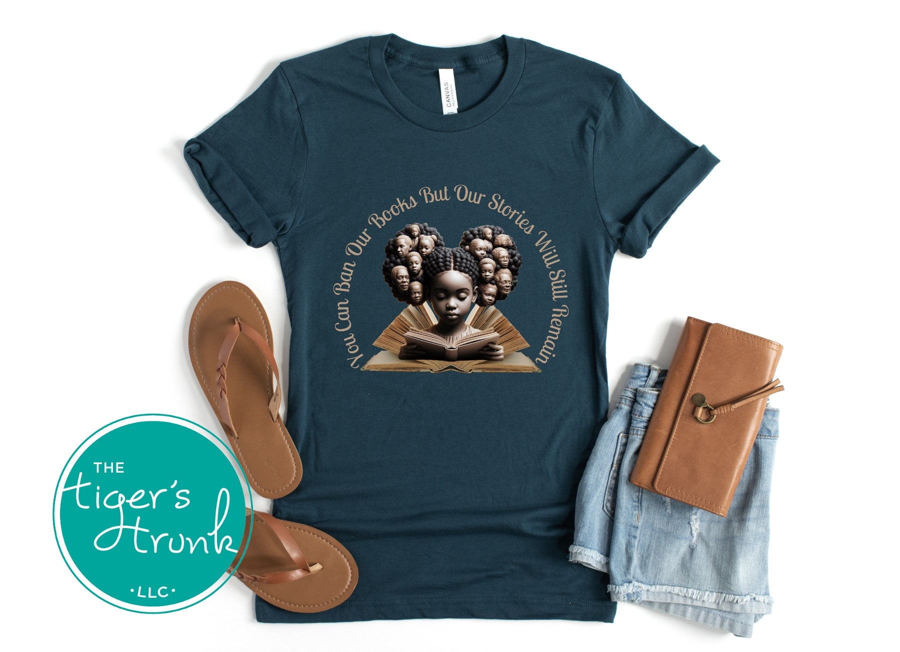 Teal t-shirt with graphic design and accessories on a white background
