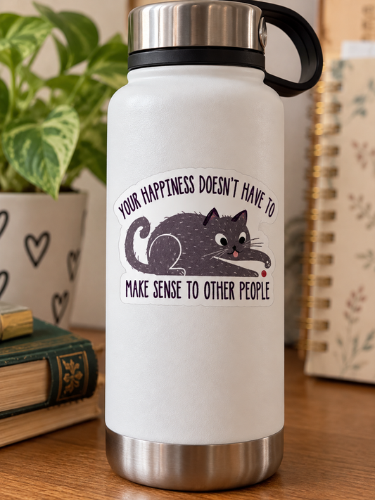 Cute gray cat sticker featuring a playful kitty reaching for a red dot with the inspirational saying Your Happiness Doesn't Have to Make Sense to Other People.
