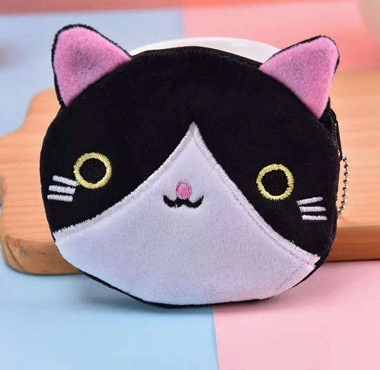 Plush cat-shaped coin purse on a colorful background